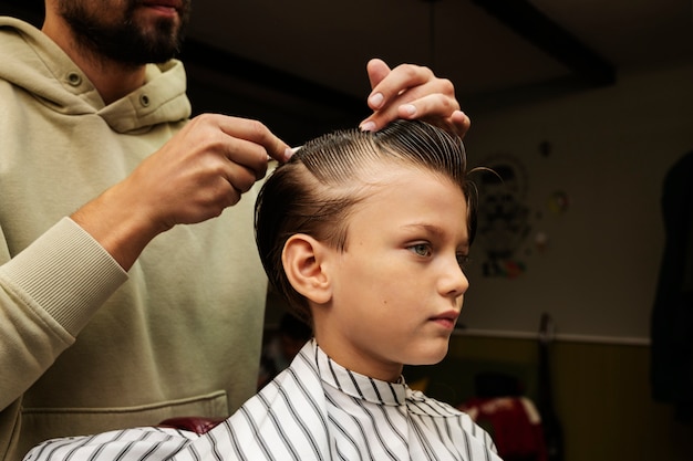 Hairdresser holding comb side view