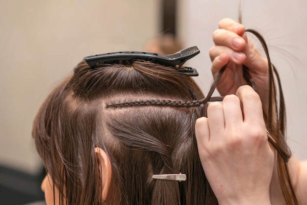 hairdresser styling a client's hair at the salon