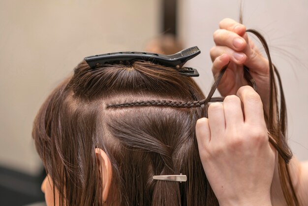 Hairdresser styling a client's hair at the salon