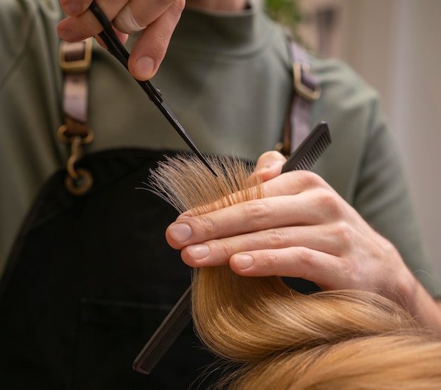 Hairdresser taking care of a client's hair indoors