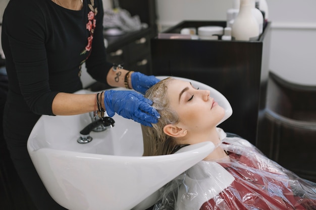 Hairdresser taking care of client in salon