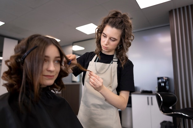 Hairdresser taking care of her client