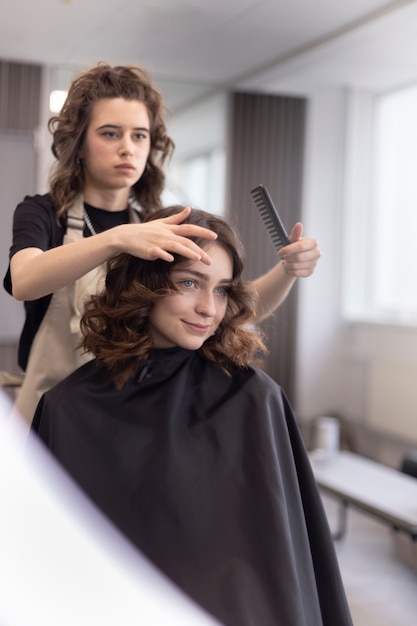 Hairdresser taking care of her client