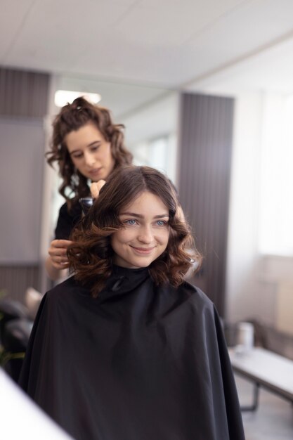 Hairdresser taking care of her client