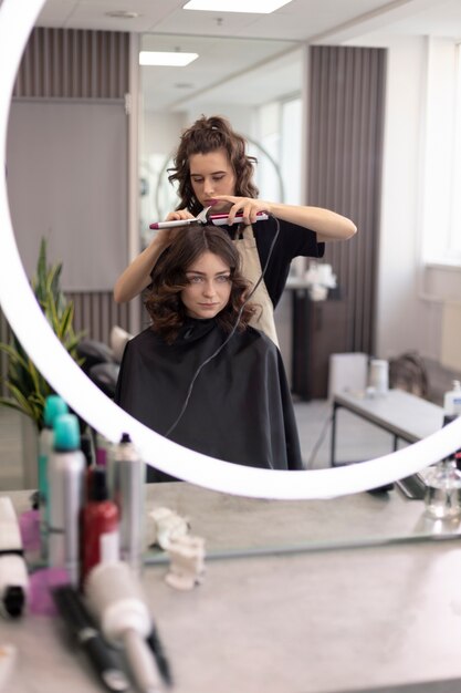 Hairdresser taking care of her client