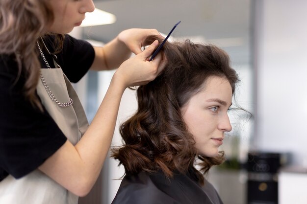 Hairdresser taking care of her client