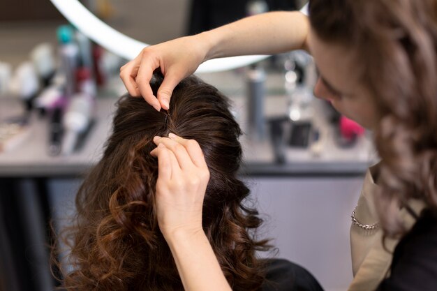 Hairdresser taking care of her client