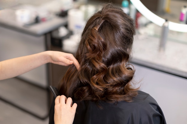 Hairdresser taking care of her client