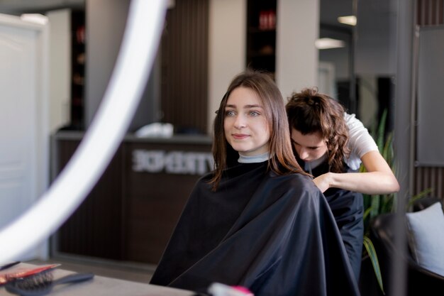 Hairdresser taking care of her client