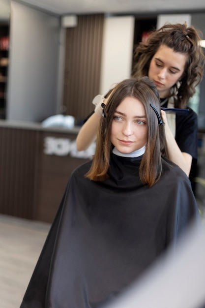 Free photo hairdresser taking care of her client