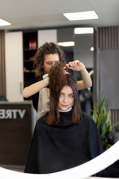 Free photo hairdresser taking care of her client