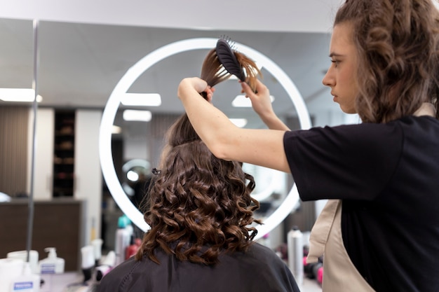 Hairdresser taking care of her client