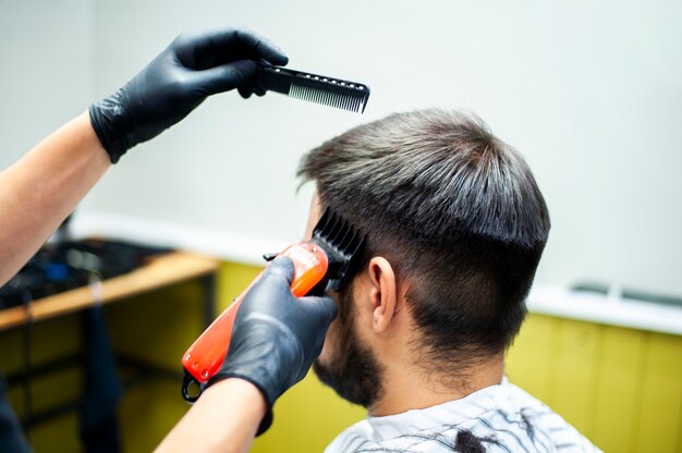 Hairdresser trimming customer hair