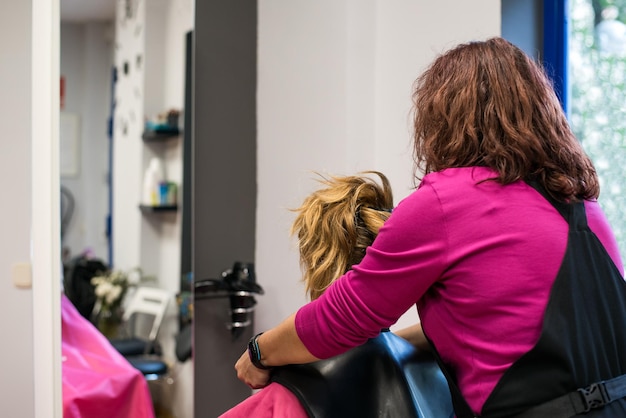 Hairdresser with woman client