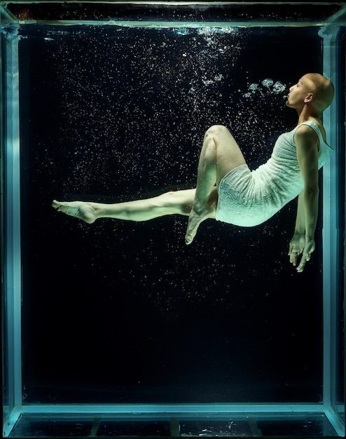 Hairless woman under water