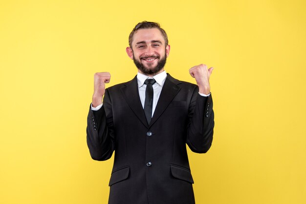 Half body portrait of smiling young man with proud facial expression