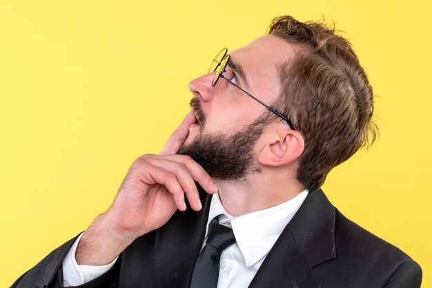 Half body portrait of a young business person brainstorming by looking up