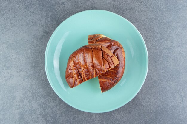 Half-cut homemade pastry on blue plate.