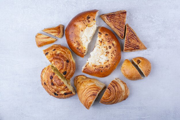 Half cut sweet pastries with cheese and raisins.