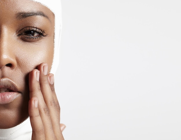 Half a face of a black woman with a bandaged head closeup