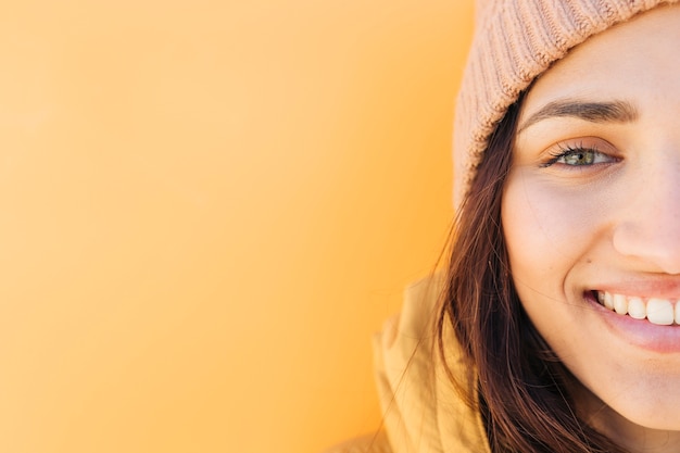 Free photo half face portrait of a smiling woman