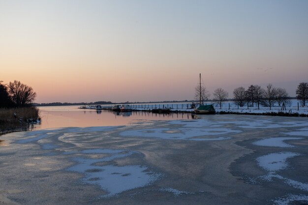 Half-frozen sea under a clear sky at the winter