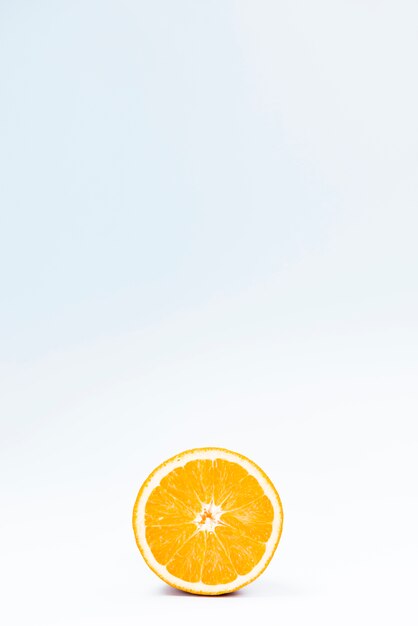 Half of juicy citrus fruit on white blue background