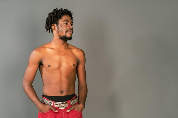 Half naked african american man posing on camera isolated on grey background Topless african american man