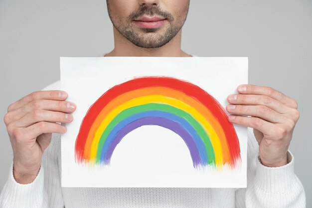 Half portrait of queer person in white blouse