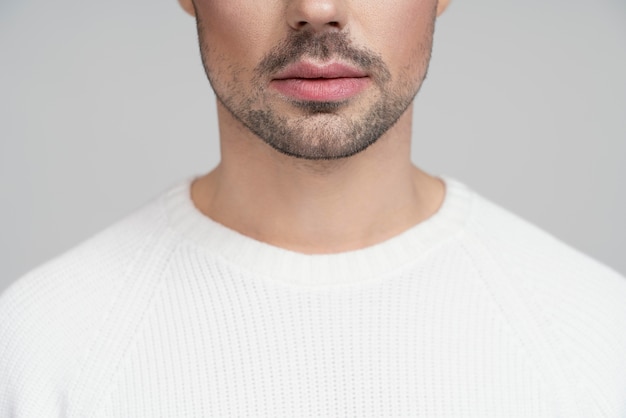 Half portrait of queer person in white blouse