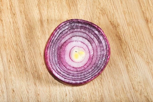 Half red onion on a wooden.