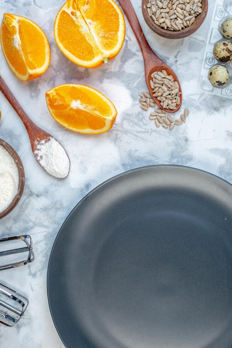Free Photo half shot of black plate and ingredients for the healthy food set on ice background
