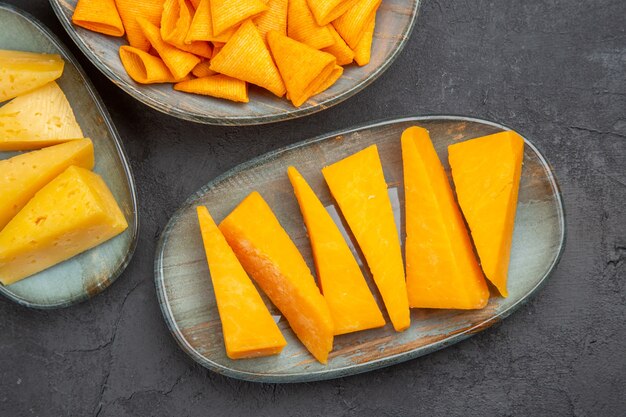 Half shot of delicious snacks for parties on a dark background