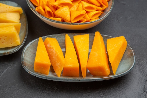 Half shot of delicious snacks for parties on the left side on a dark background