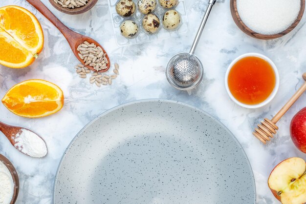 Half shot of empty gray plate and ingredients for the healthy food set on ice table