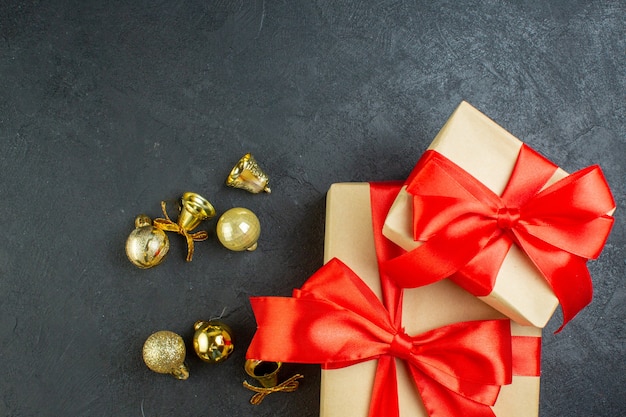 Half shot of gift box with red ribbon and decoration accessories on black background