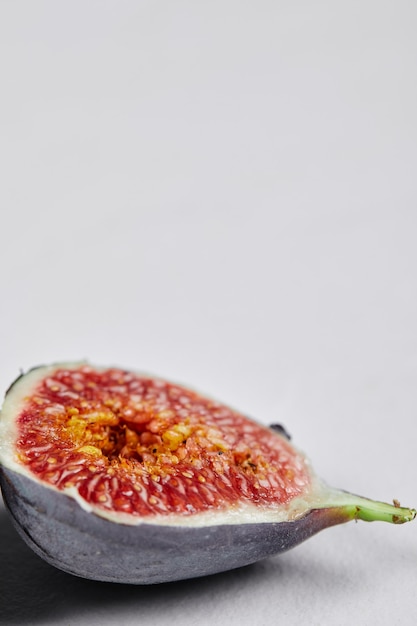 Free photo half slice of ripe fig on white.