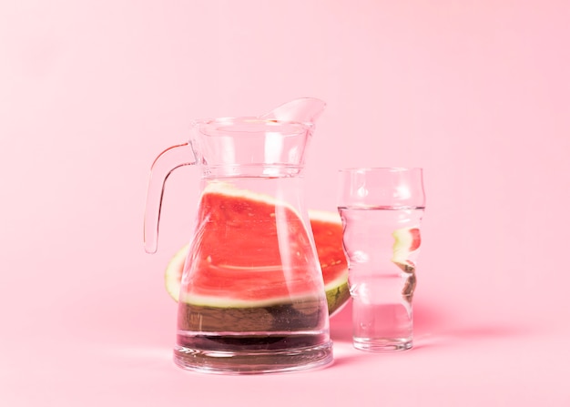 Half sliced watermelon with water containers