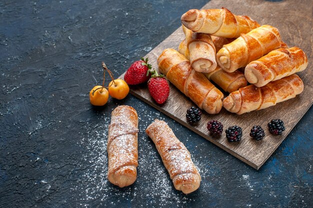 Half-top close view delicious sweet bangles with filling yummy baked with fruits on dark desk, bake cake biscuit sugar sweet dessert