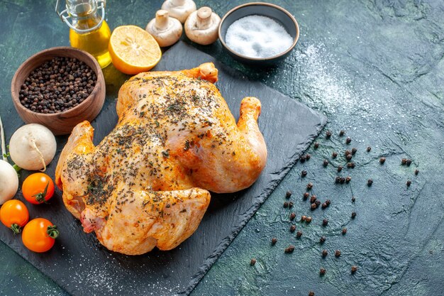 Half-top view cooked spiced chicken on dark surface