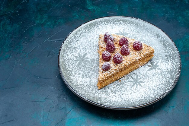 Half-top view of delicious cake slice with fruits and sugar powder on dark surface