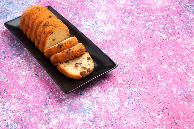 Half-top view delicious cake sweet and yummy sliced on pink desk.