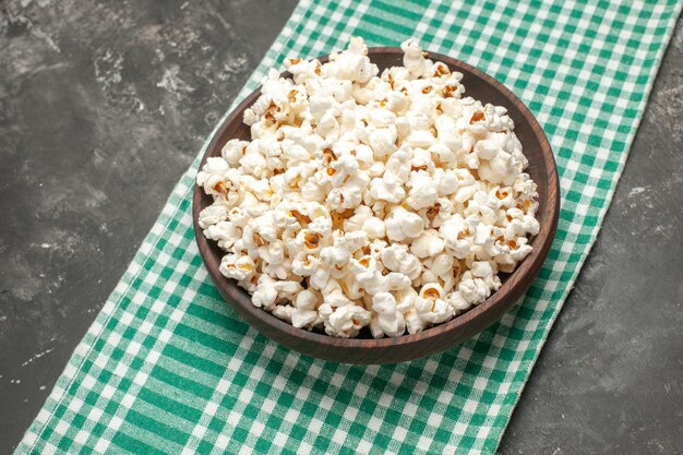 Half-top view fresh popcorn on dark background