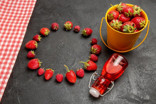 Half-top view fresh red strawberries on dark table fruit berry color raspberry