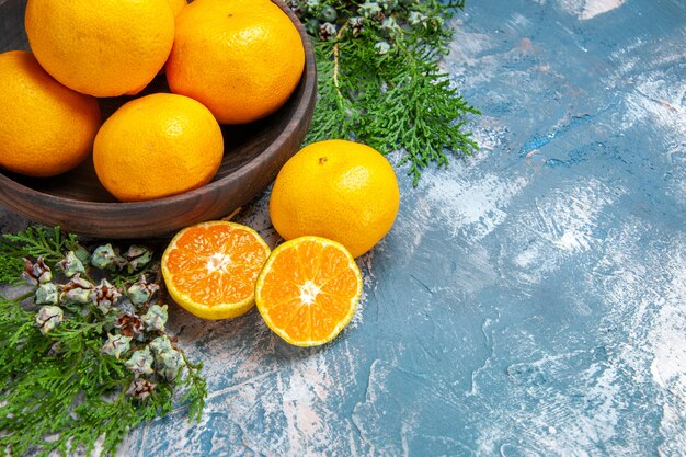 Half-top view fresh tangerines on light-blue background