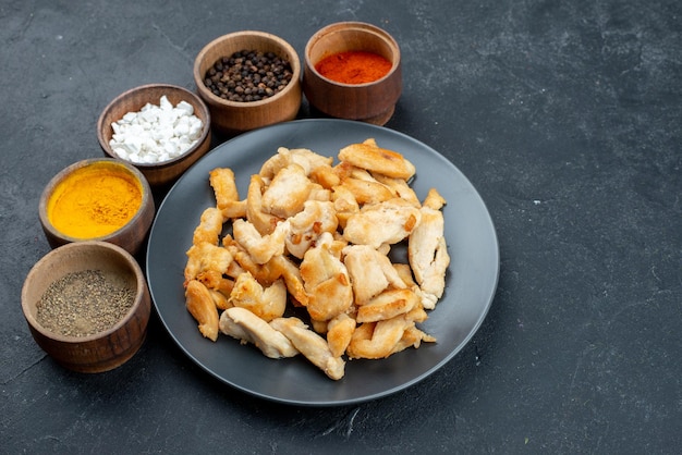 Half-top view tasty chicken slices with different seasonings on dark background meat food bird dinner dish color salad meal