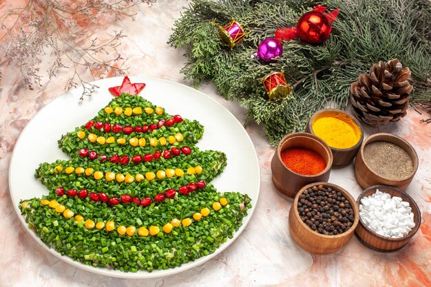 Half-top view tasty green salad in new year tree shape on light background