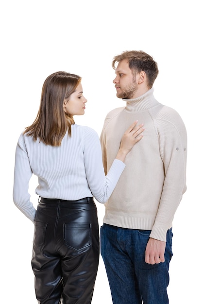 Halflength portrait of young loving couple posing hugging isolated over white studio background