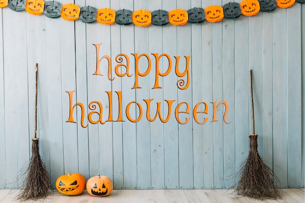 Halloween banner with brooms and pumpkins