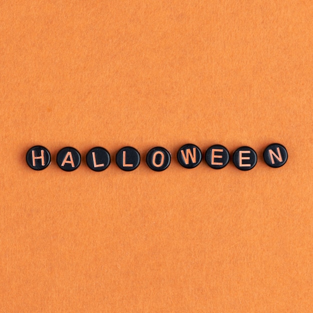 Free photo halloween beads text typography on orange